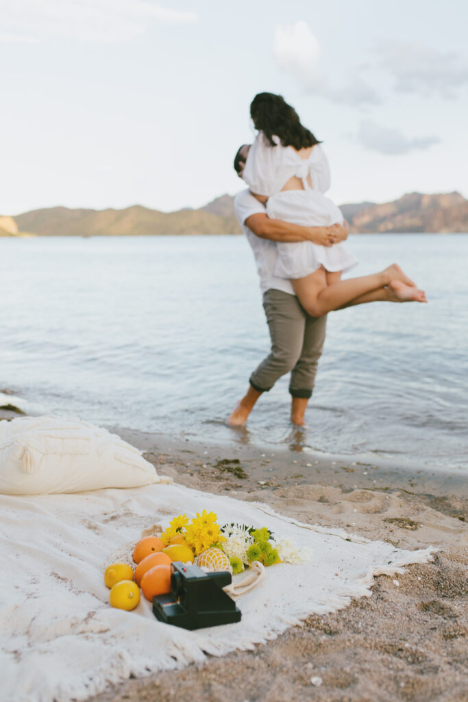 Include a prop in your engagement session. Waterfront picnic