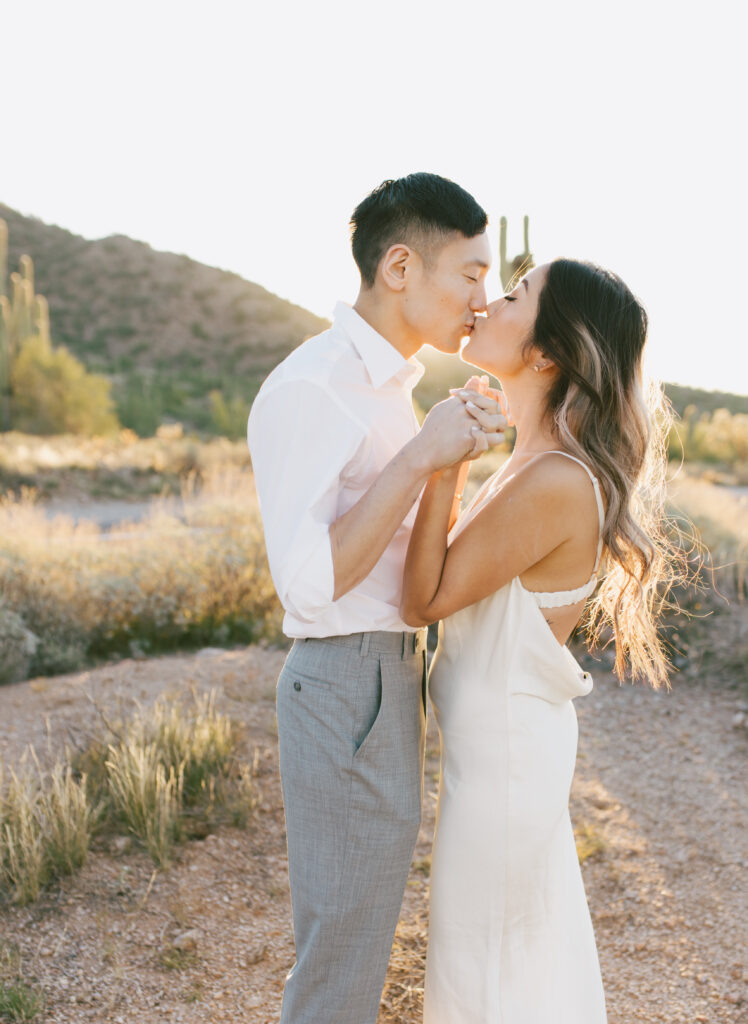 J and Alice's Arizona Sunrise Engagement Session sharing a tender kiss and embrace