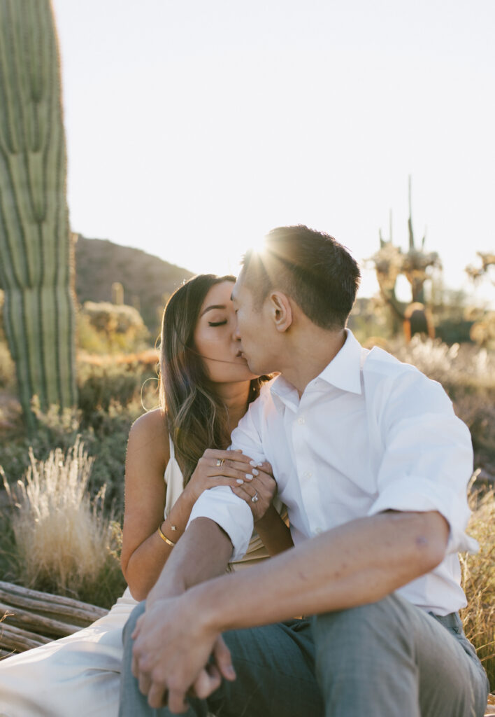 J and Alice's Arizona Sunrise Engagement Session sharing a tender kiss