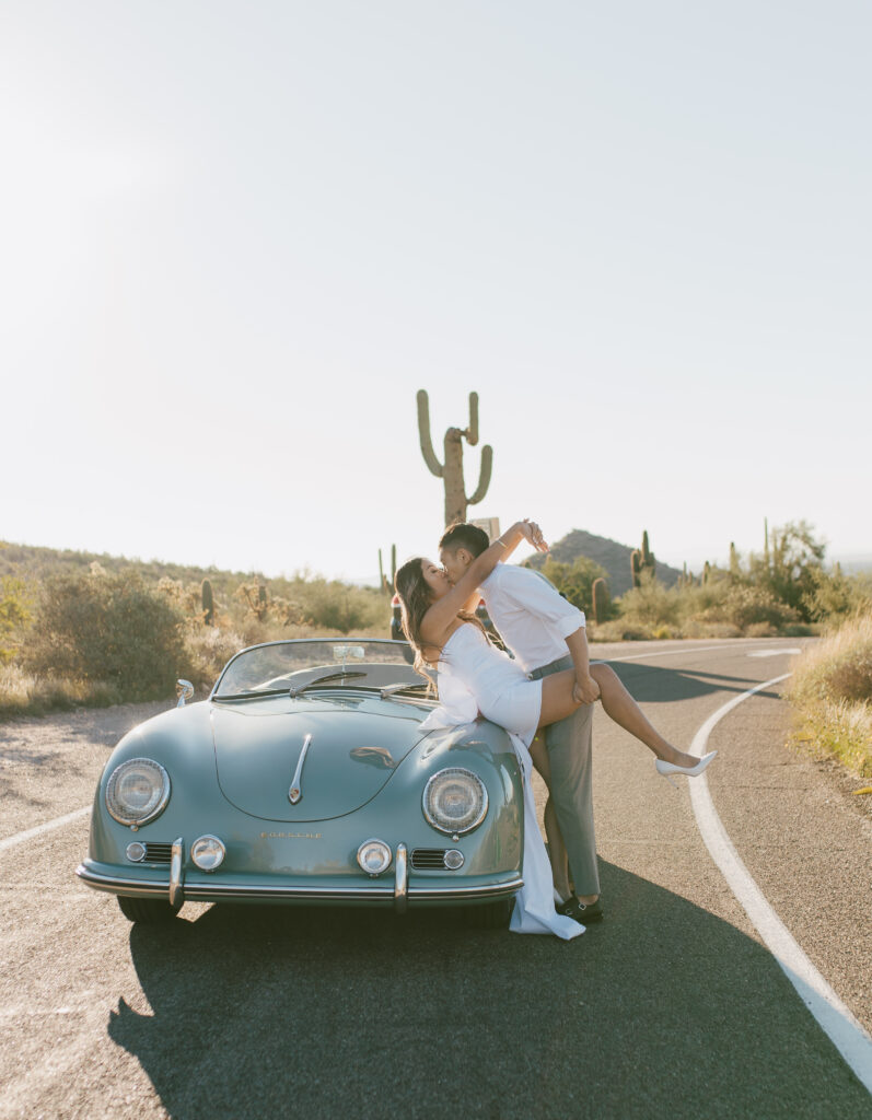 J and Alice's Blue Classic Car Arizona sunrise Engagement Session. J & A sharing a passionate embrace