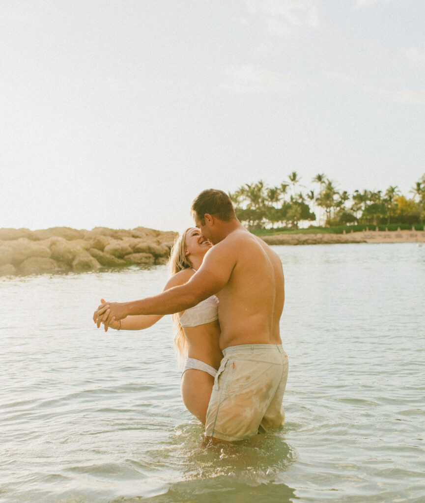 Candid Gabby and Kyle during Oahu Engagement Session in the ocean during Sunset