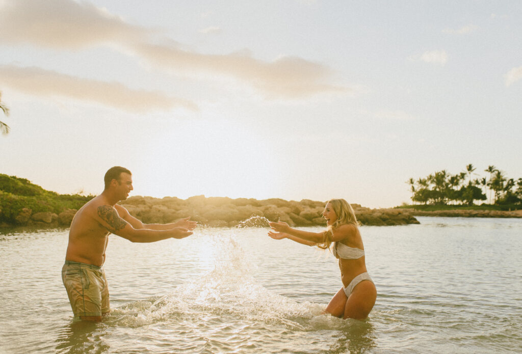 Oahu Engagement Session in the ocean with a sunset view