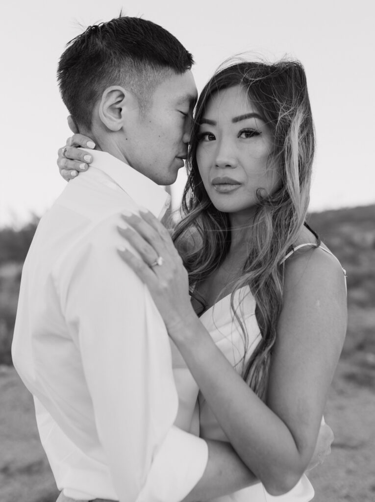J and Alice's Arizona Sunrise Engagement Session sharing an intimate embrace black and white