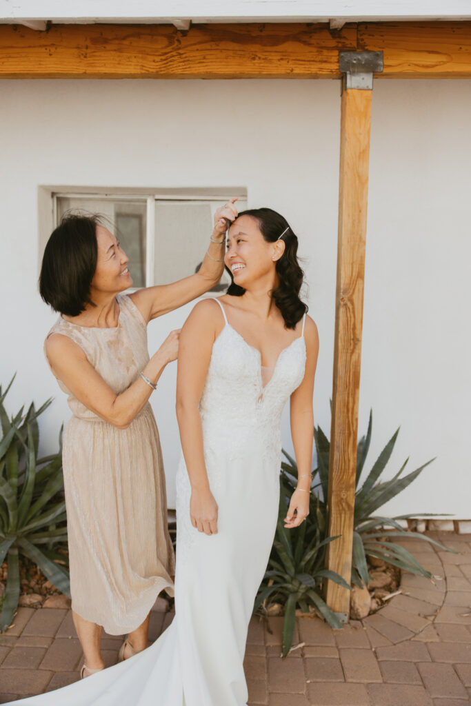 Bride getting ready with her mom at a AirBnb on her wedding day.