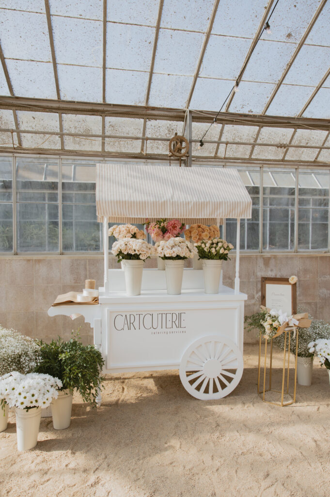 A flower cart for wedding guests to create their own flower bouquet.