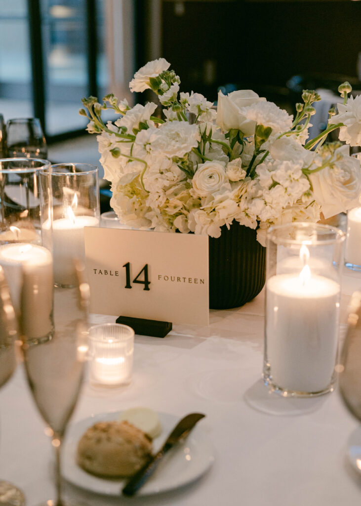 Black and White Wedding Color Palette displayed on a wedding reception table with candles. 