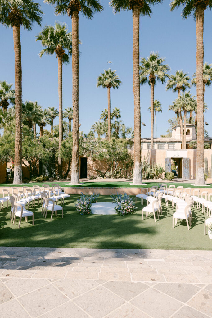 A romantic outdoor wedding ceremony at Royal Palms Resort, featuring lush gardens and Mediterranean-style architecture.