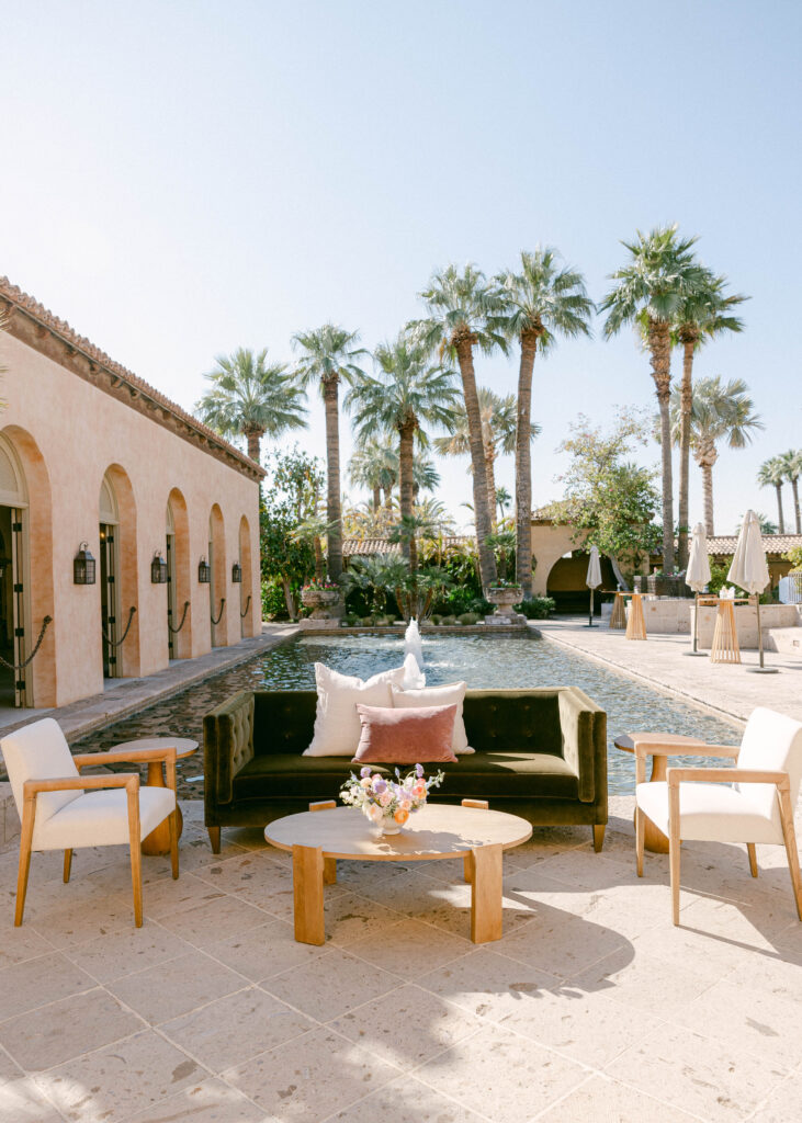 Elegant cocktail hour at Royal Palms Resort, featuring the tranquil reflecting pool surrounded by lush greenery and Mediterranean-style architecture.