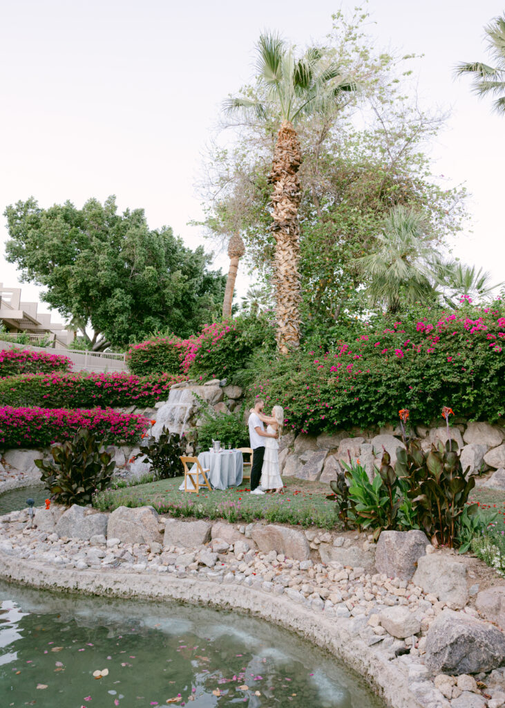 A romantic engagement proposal at The Phoenician wedding venue in Scottsdale Arizona, featuring lush gardens and a breathtaking Camelback Mountain backdrop.