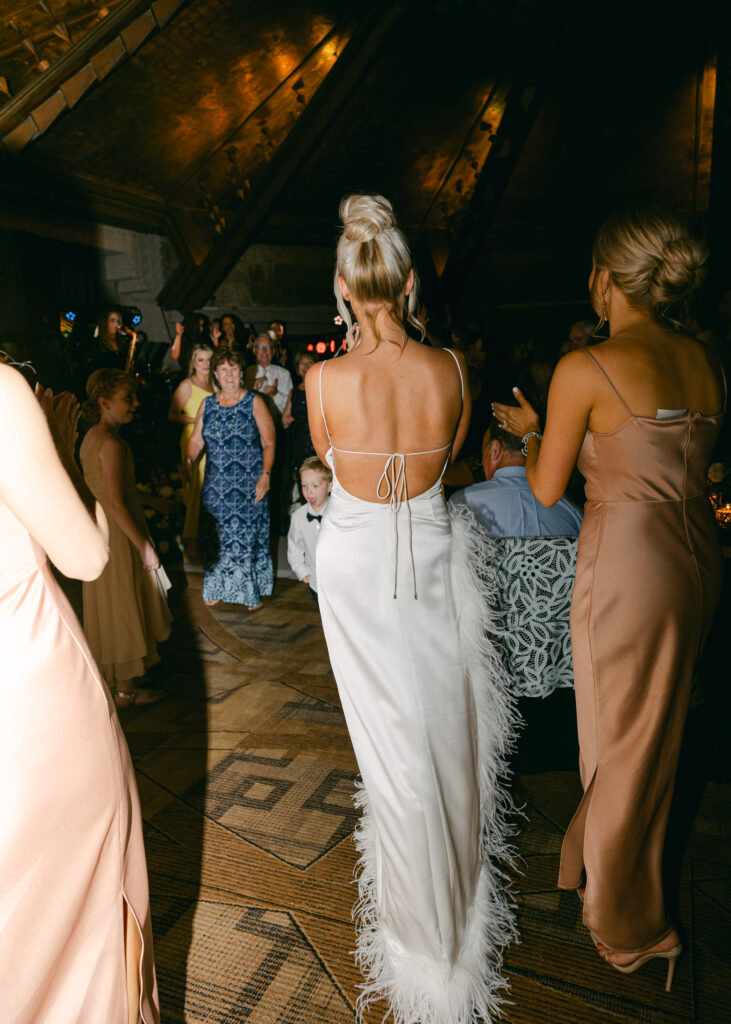 A joyful wedding reception at the Arizona Biltmore, with guests dancing under elegant lighting in the historic ballroom.