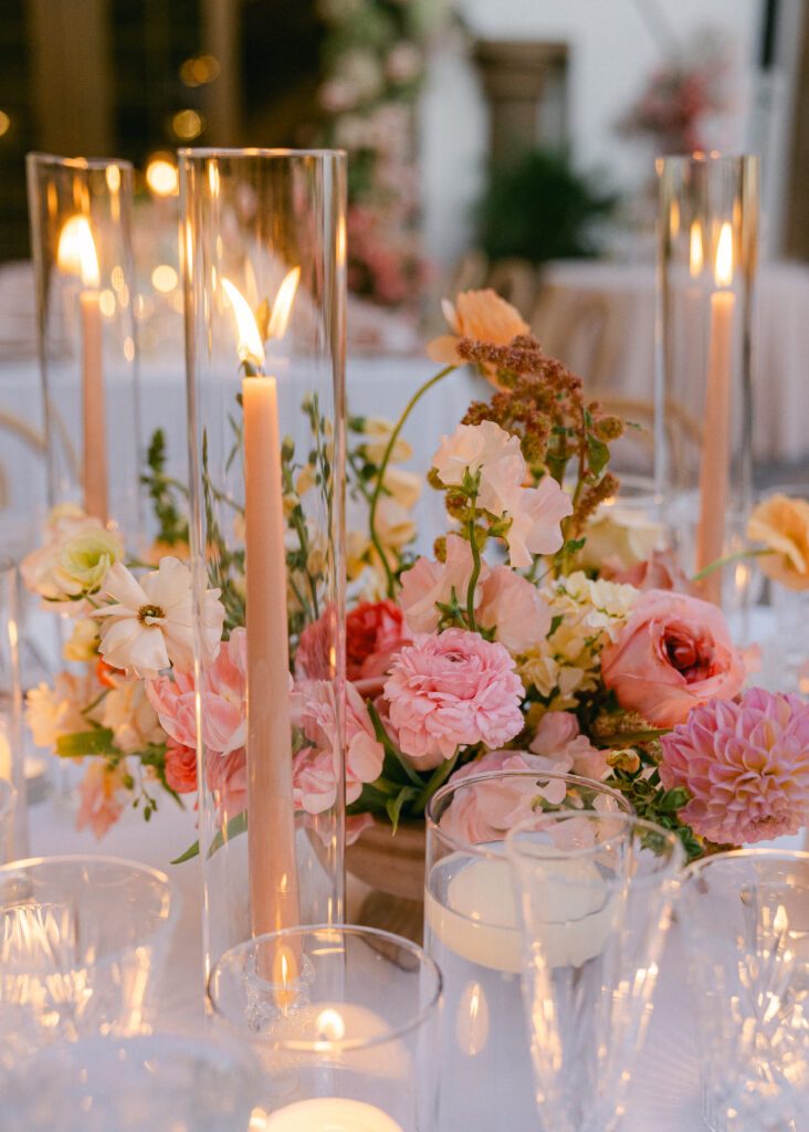 Elegant wedding reception table featuring soft pink florals, romantic candlelight, and luxurious details for a dreamy atmosphere.